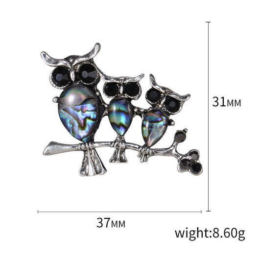 Seashell owl brooch