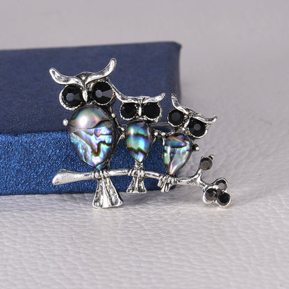 Seashell owl brooch