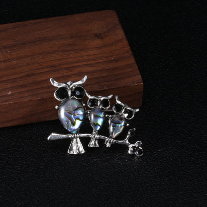 Seashell owl brooch