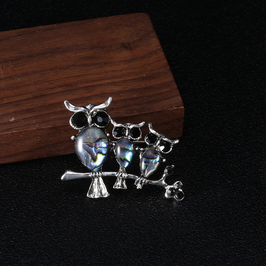 Seashell owl brooch